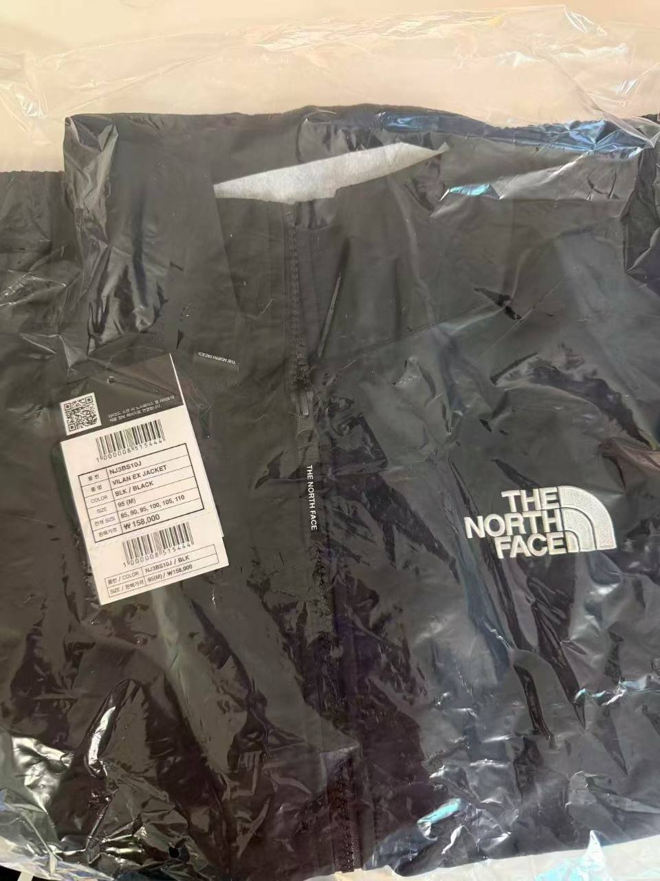 Black The North Face VILAN EX JACKET NJ3BS10J in packaging with its attached size tag
